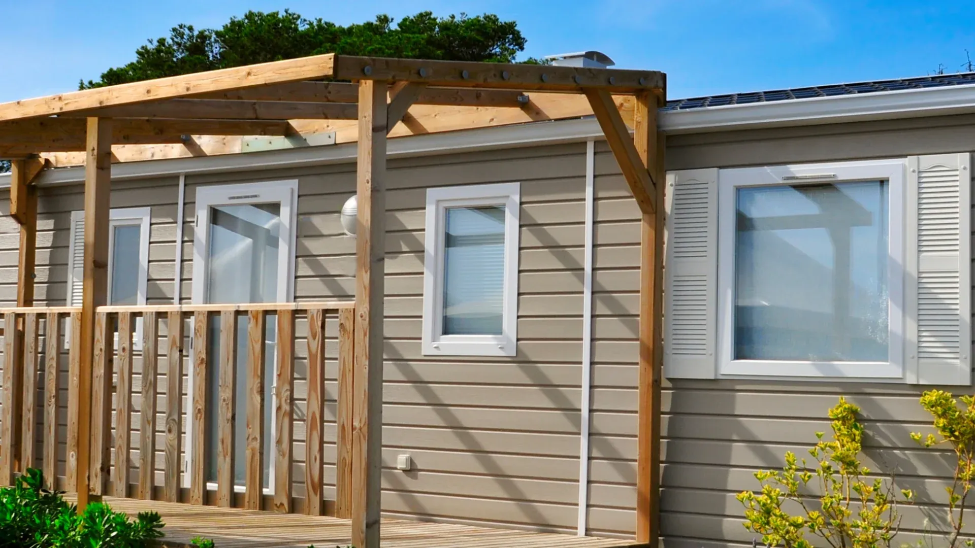 A home with brown siding and white trim windows