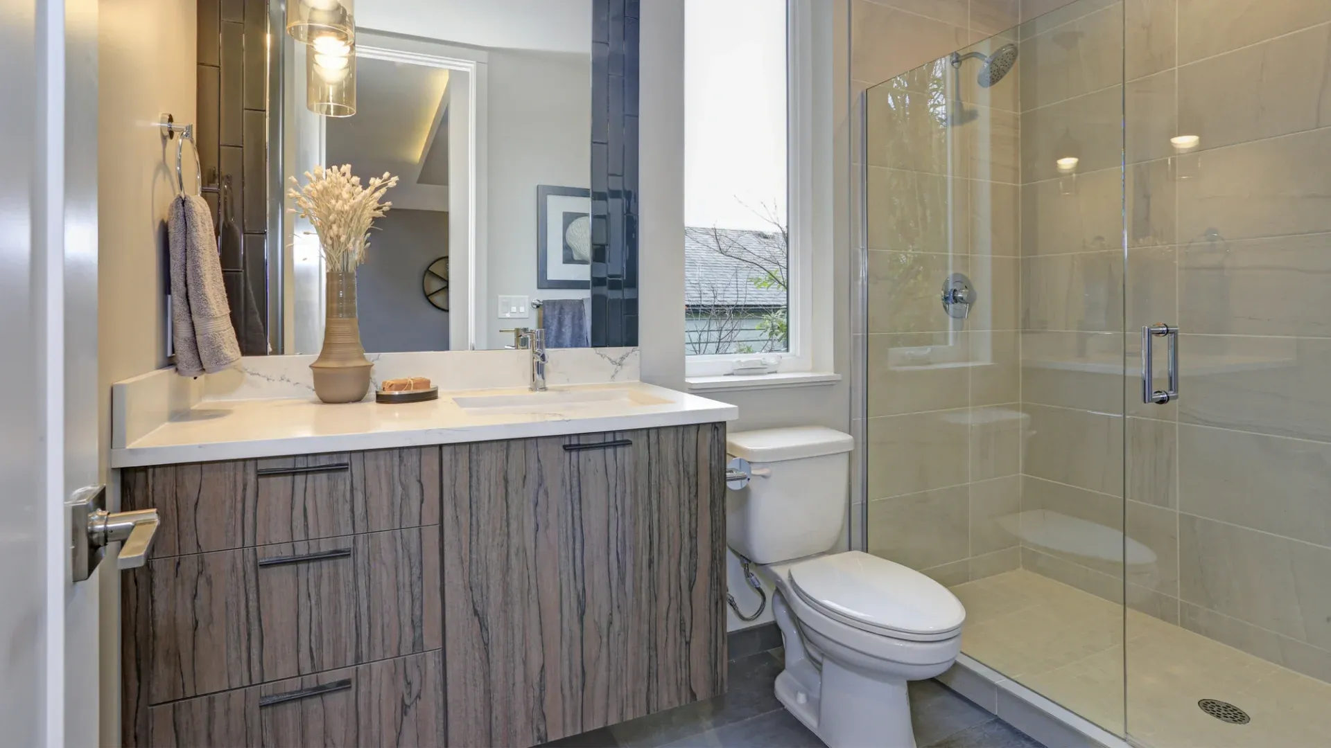 A bathroom with a detailed brown and white vanity and a white walk-in shower