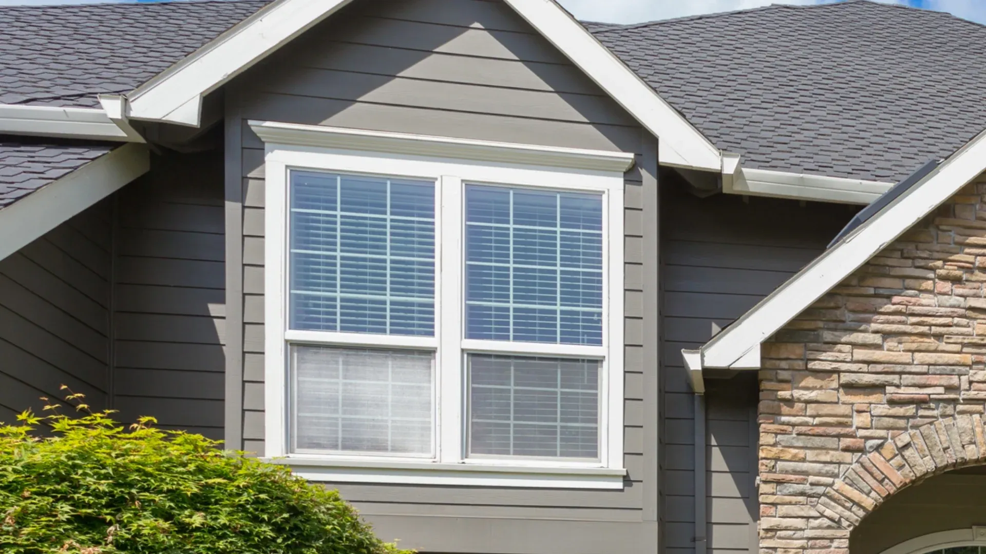 White trim windows in a home with gray siding and white trim