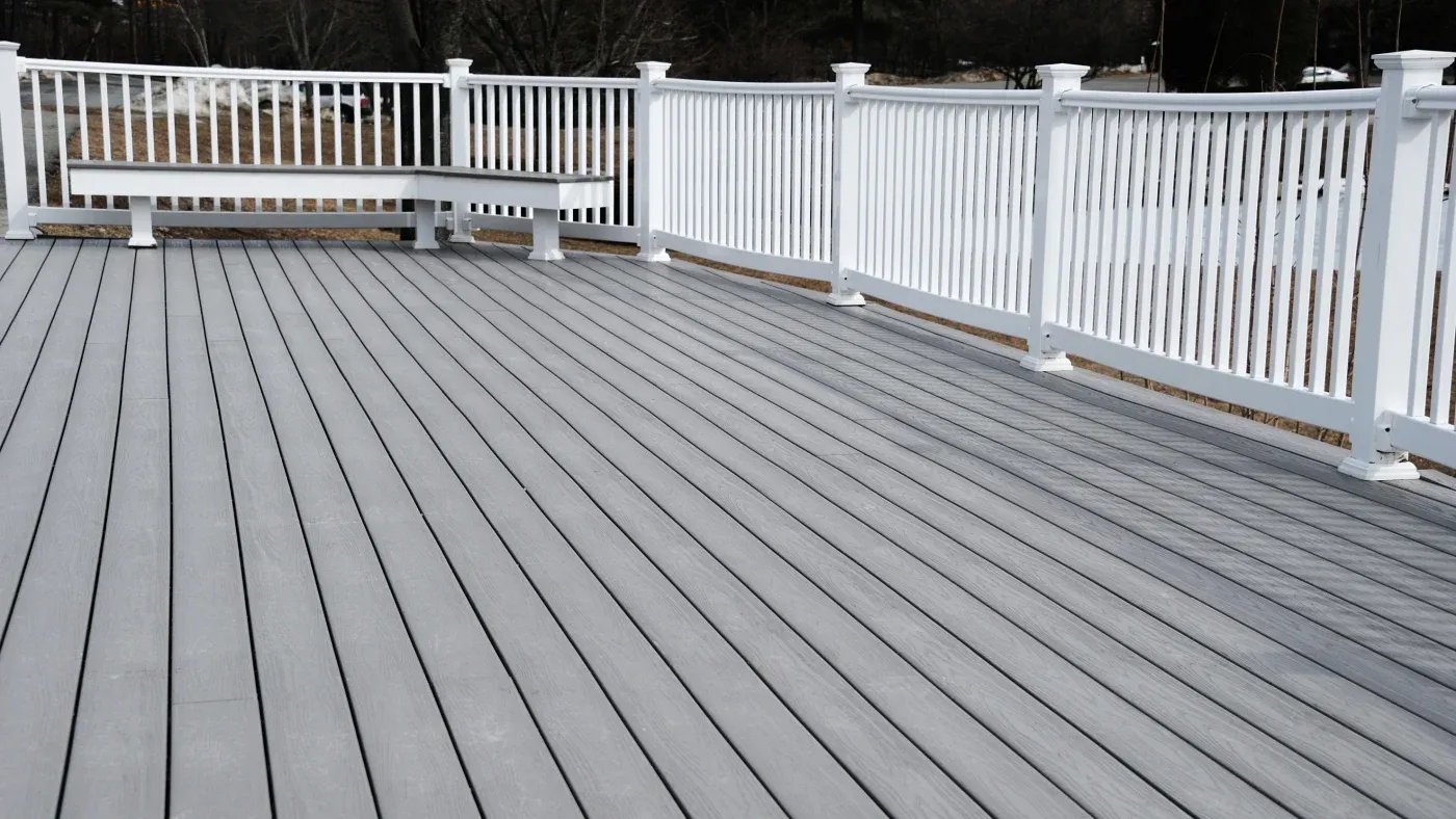 A gray deck with white railings
