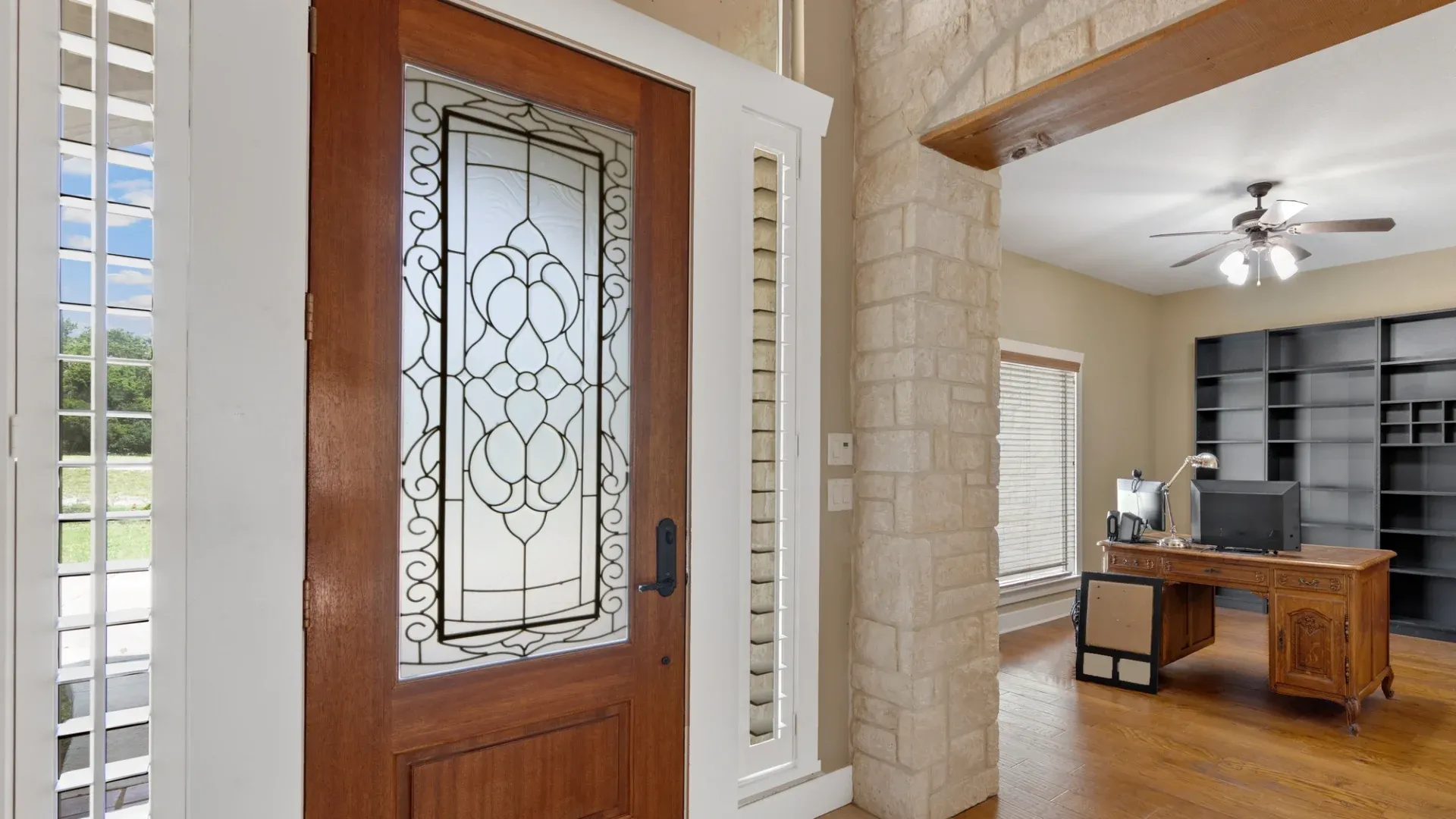 A brown door with a detailed glass pane