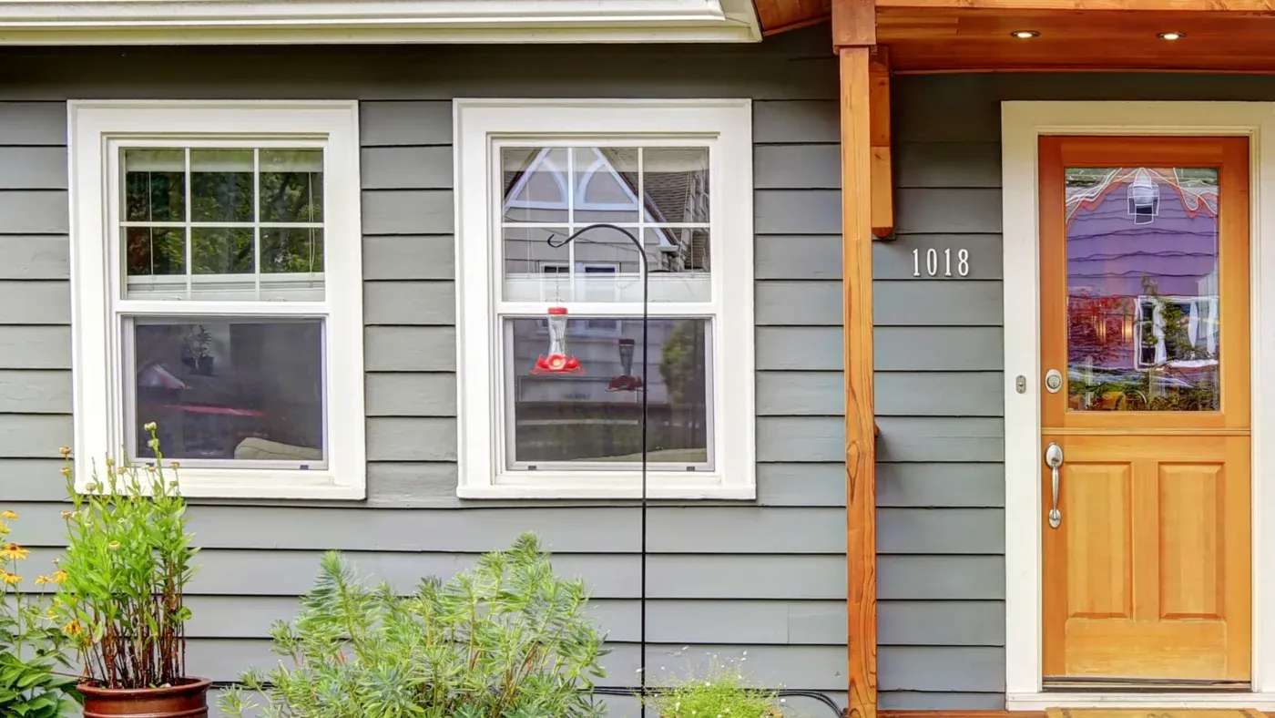 White windows in a home with green siding