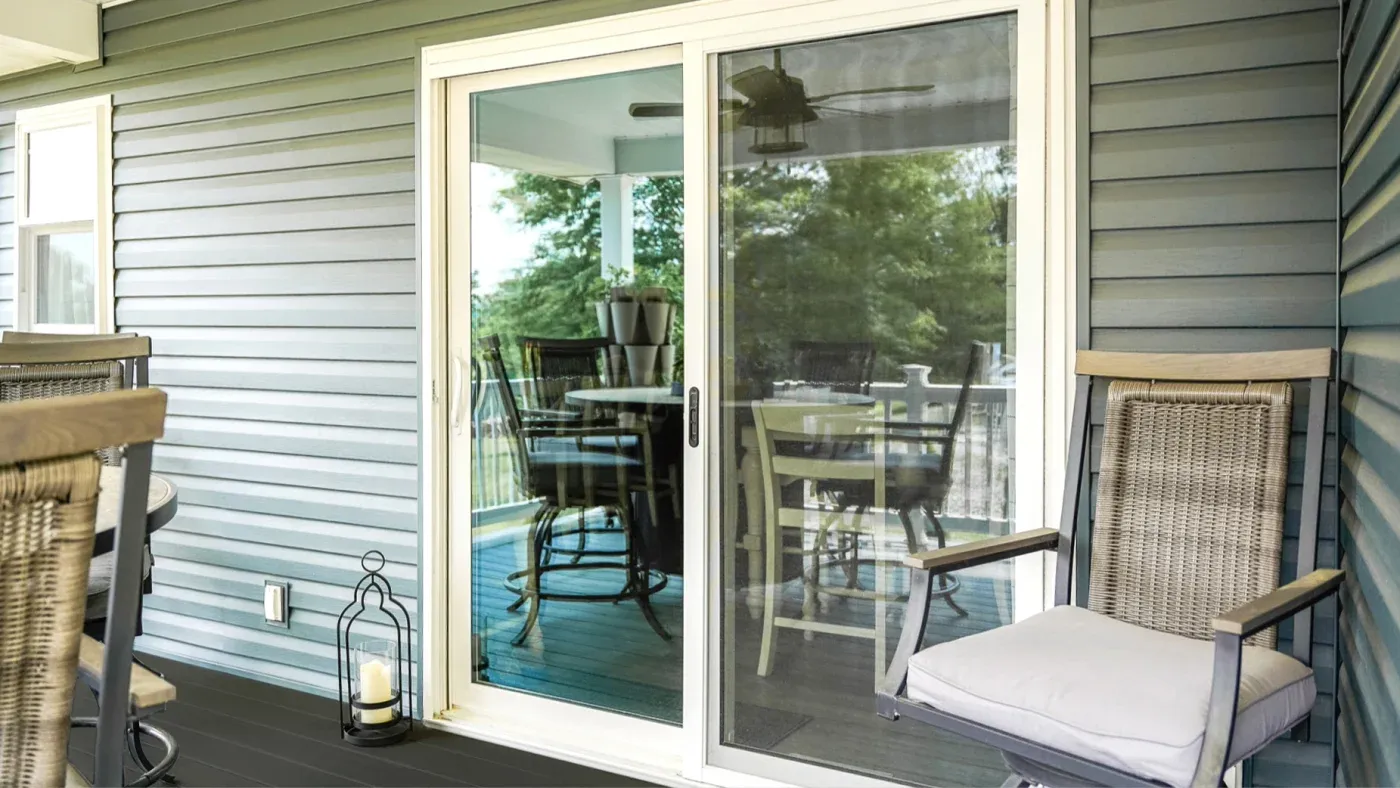 White patio doors in a home with blue siding