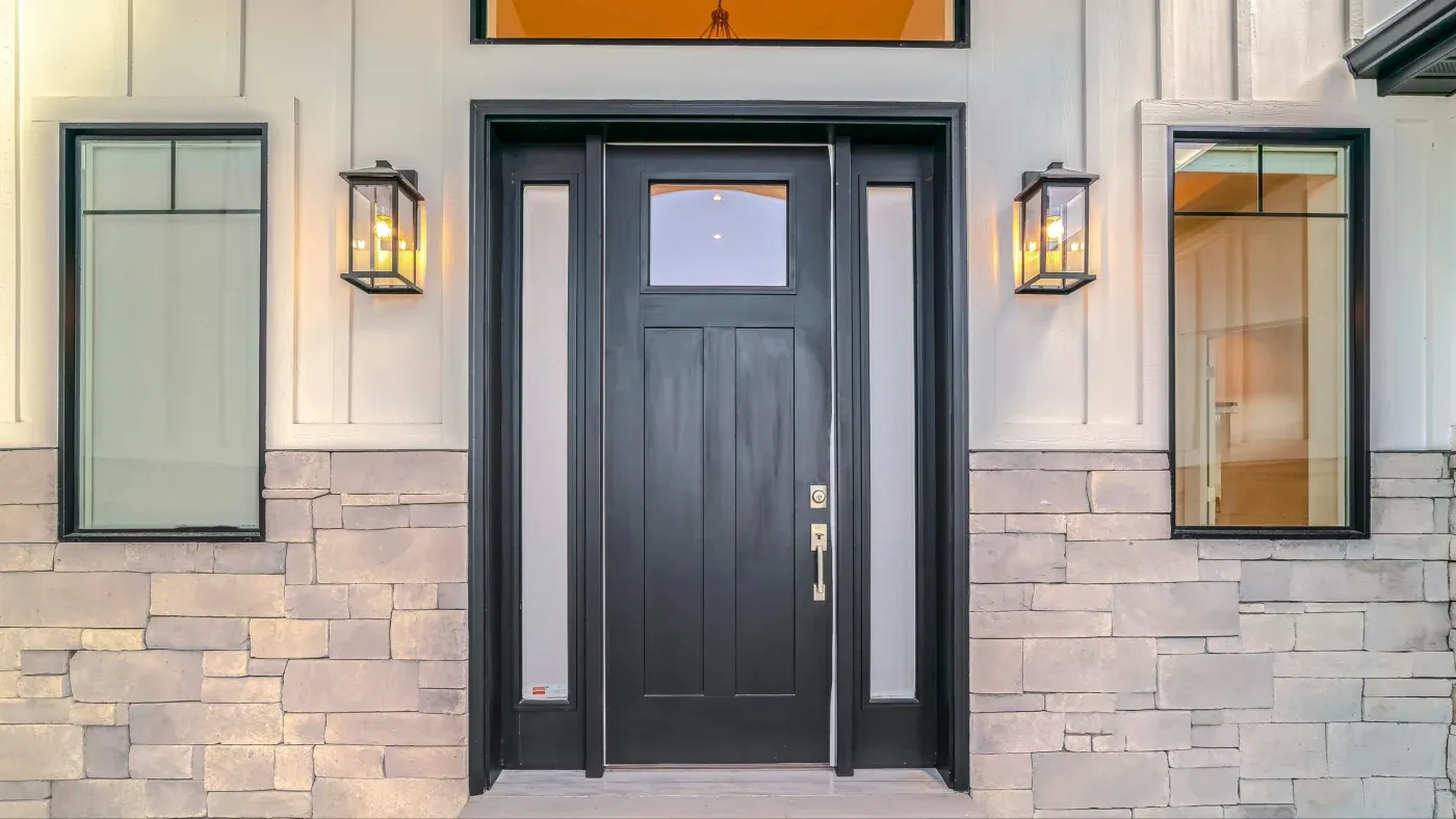 A black entry door with simple glass panes